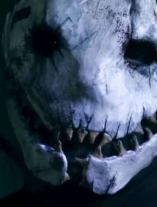 A shot of The Trapper from Jared Cline's 'The Trapper' short film. It shows a bone-white mask, its features pulled into a jagged, toothy grin.